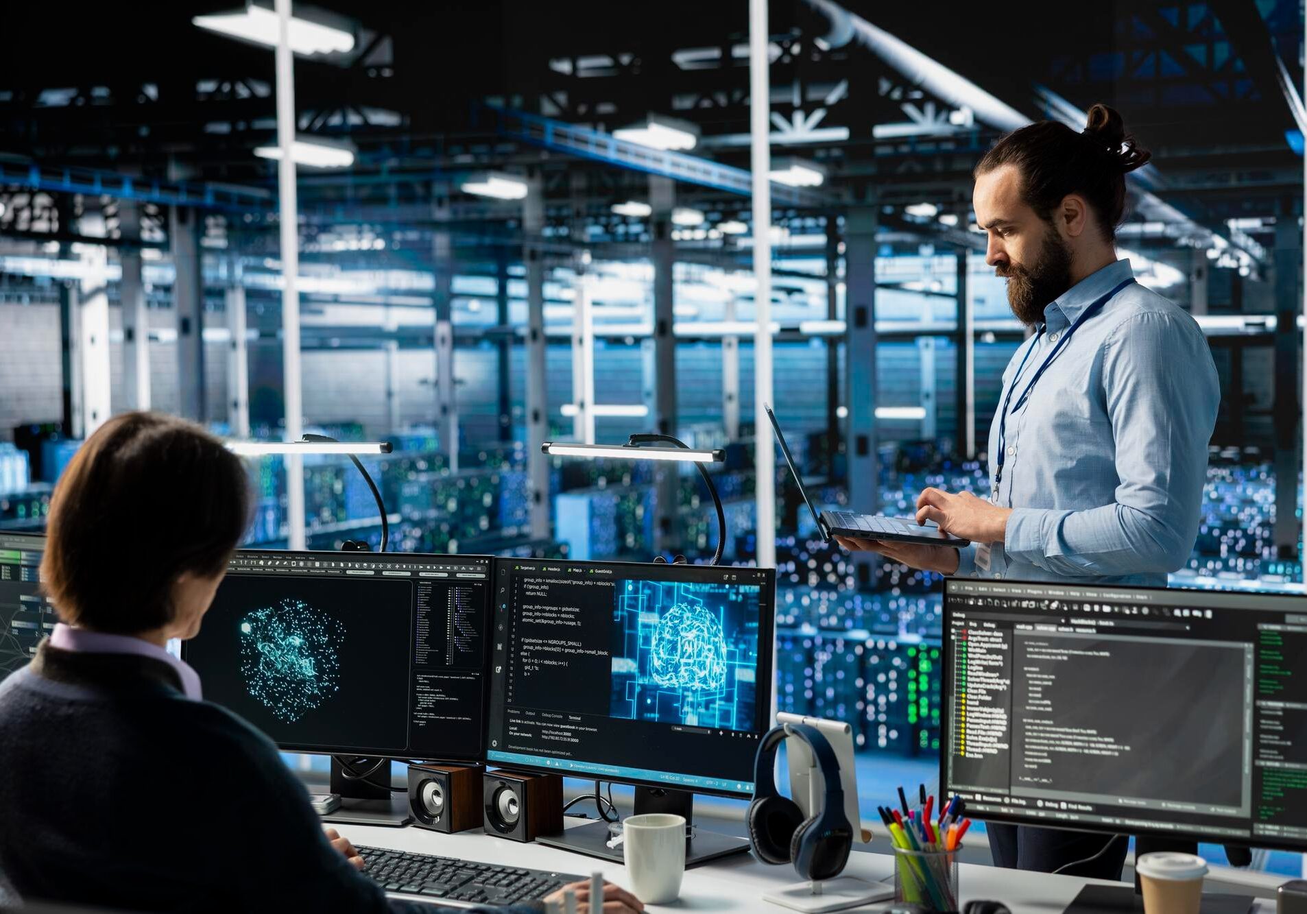 Two professionals analyze cybersecurity data on multiple monitors in a modern office.