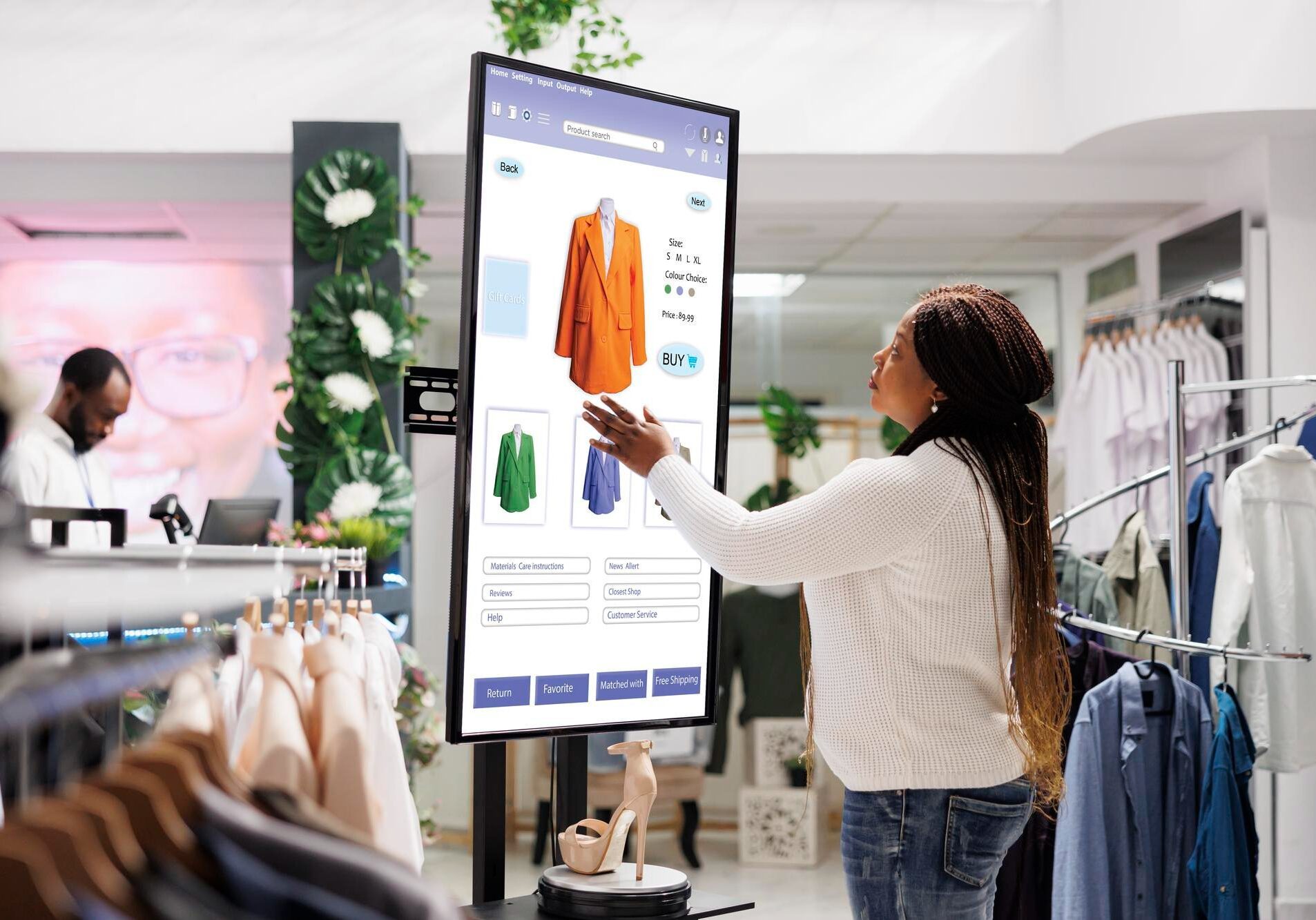 Woman interacting with a digital shopping kiosk in a clothing store.